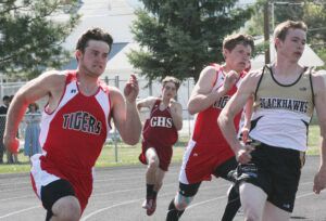 Darby's Colton Johnston and Storm Darby’s Colton Johnston and Storm Wanstrath as well as Seeley-Swan’s Christian Cahoon round the corner in the 200 time trials at the District 13C track meet. Wanstrath won the event. Jean Schurman photo