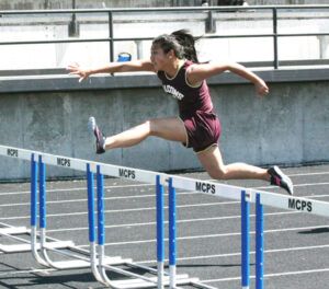 Hannah Sax shows the form that propelled her to first place in both the 100 and the 300 hurdles. Jean Schurman photo