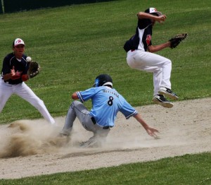 Brett Huxtable of the Bitterroot Bruins slides into second as one Helena Allstar player jumps across him and the second player catches the ball. Jean Schurman photo