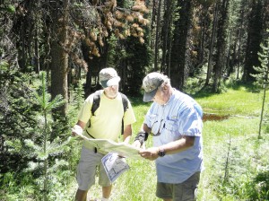 Dan Hall (left) of Western Cultural, Inc. and Ted Hall of Darby examine the maps as they stand in the meadow where Lewis and Clark and the Corps of Discovery may have slept on September 3, 1805 before heading down to Ross’ Hole where they met the Salish Indians the next day. Michael Howell photo.