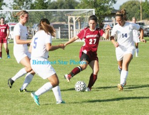 Hamilton’s Bri Huggans keeps her focus on the ball and not the Corvallis players surrounding her. The Corvallis players are Jessica Cassens (7), Megan Brouwer (5) and Katie Landis (14). Jean Schurman photo