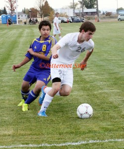 Stevensville’s Ian Perry maneuvers the ball towards the goal as Libby’s Giovanni Cano tries to get around him. Jean Schurman photo