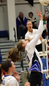 Corvallis’ Joanna Avery goes up for a kill as Alex Price looks on. Jean Schurman photo
