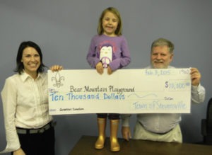 The Town of Stevensville shows their support for Bear Mountain Playground in the form of a check for $10,000. Shown with Mayor Gene Mim Mack are Renee Endicott, Steering Committee co-chair, and her daughter Gianna Ruprecht. Michael Howell photo.