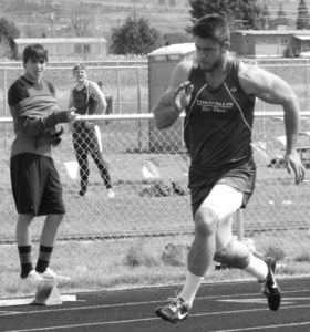 Jesse Sims explodes from the blocks in the 200 as Darby’s Kai McCollaum watches. Jean Schurman photo.