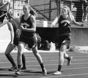 Ally Rust hands the baton to Autumn Round in the 1,600 relay race at the 6B district track meet. Florence won the event and moves on to Divisionals. Jean Schurman photo.