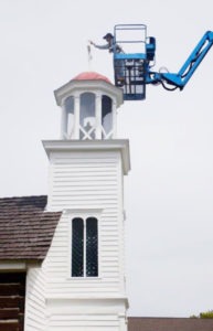 Chris Weatherly of Bitter Root Woodwright puts the final touches on the cross that graces the cupola atop St. Mary’s Mission chapel in Stevensville. The church is being restored in preparation for the 175th anniversary of the founding of the Mission. The celebration is scheduled for September 24, 2016. 