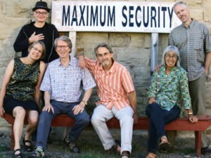 The 2015 edition of the Mudflaps features Maureen Powell, Chuck Florence, David Horgan, and Beth Lo, seated, with Jim Rogers and Rich Brinkman, standing.