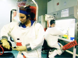 Dr. Andrea Marzi (left) and Dr. Dave Safronetz wearing positive pressure suits in an inactive BSL-4 laboratory at RML. Photo courtesy of NIAID.