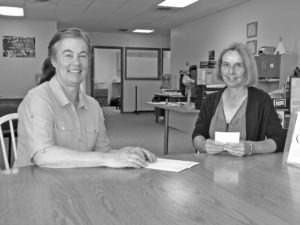 New RSVP Area Director Colleen Murphy Southwick (left), and local Volunteer Coordinator Janelle Corn in their new Main Street quarters in Hamilton. They’ll be welcoming the public to an open house on Monday, Aug. 24, from 11 to 4 p.m. Russ Lawrence photo.