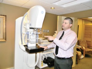 Drew Hayward, Department Head for Imaging at Marcus Daly Memorial Hospital, points to the new 3-D tomography machine in the mammogram department which has turned the place into a one stop shop for mammograms including, if needed, a stereotactic biopsy that can be done on the spot.