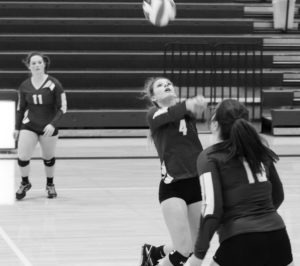 Hamilton’s Caitlin Dillon sets the ball for Jordan Bauder (13) as Brooke Huxtable keeps an eye on the action. Jean Schurman photo.