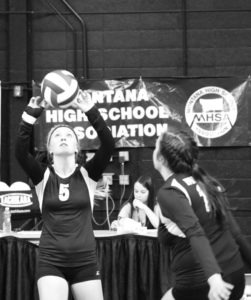 Rylie Hawkins sets the ball for Jessica Dufresne at the state Class B volleyball tournament. Kelly Ostheimer photo.