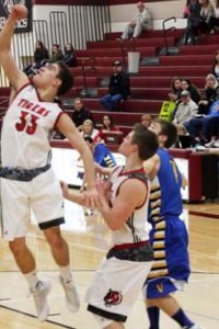 Darby’s Andy Smith makes a lay-up with teammate John Beckers and Victor’s Connor Wilson looking on. Jean Schurman photo. 