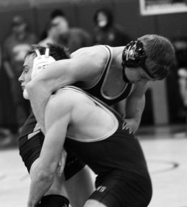 Dean Klakken (in the white headgear) works to get an advantage over teammate Kyler Pancake in the quarterfinals at 138 pounds at the Western B Divisional wrestling tournament in Florence. Jean Schurman photo.