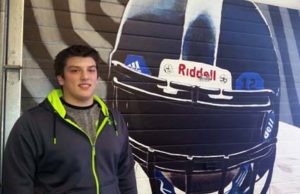 Luke Channer stands in front of a mural in the Corvallis High School weight room. Jean Schurman photo.