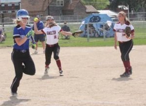 Hamilton’s pitcher, Jordan Taggart, throws to first base for the out. Taia Tully of Corvallis is the runner and Rachel Ringer of Hamilton is providing backup. Jean Schurman photo.