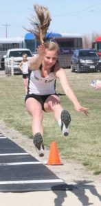 With help from her ponytail, Stevensville’s Megan Pendergast leaps in the long jump. Jean Schurman photo.