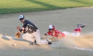 Tylor Nixon slides into third base as the ball passes by the Glacier Twins third baseman Tristan Steinwand. Nixon went on to steal home for the run. Jean Schurman photo.