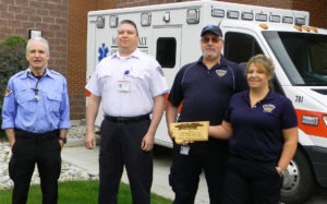 Mark Butler, William Torres, Roy Perry and Gina Tan, members of Marcus Daly Hospital Ambulance Service, with the plaque they received EMS Service of the Year.