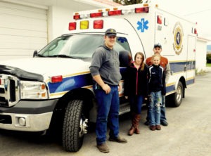 L to r: Austin Gagnon, Christa Mertins, Madison Bahr and Jason Bahr delivered Victor’s new ambulanceto the Victor Fire District garage.