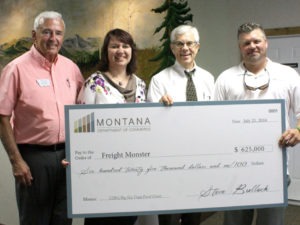 Lt. Governor Mike Cooney delivered a check for $625,000 last Thursday to FreightMonster, Inc. located on Old Corvallis Road in Hamilton. Shown are Representative Ed Greef, Jennifer Olson of the Montana Department of Commerce Community Grants Bureau, Lt. Governor Mike Cooney, and Larry Lockhart, Jr., president of FreightMonster. Jean Schurman photo.