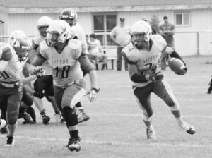 Victor’s Colt Neville turns the corner on a scoring run as his blocker, Logan McKinley, clears the way. Victor defeated Seeley-Swan, 58-6. Jean Schurman photo.