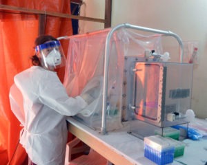 Dr. Emmie de Witt, a virologist working at Rocky Mountain Laboratory in Hamilton, is pictured here using a sealed glovebox to inactivate virus in patient blood samples prior to testing for Ebola at the ELWA3 Ebola Treatment Unit in Monrovia, where she worked as a volunteer during the height of the crisis. She has subsequently helped coordinate a study of the data collected and analyzed by scientists from around the world and a dozen organizations that shows evidence of an association between malaria causing parasites and increased survival rates of Ebola infected people. Photo courtesy of NIAID.