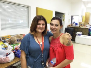 After rushing from their home in the face of a raging fire storm, Patricia Thomas and her daughter Summer find comfort and aid at the Red Cross Evacuation Center in Hamilton. Michael Howell photo.