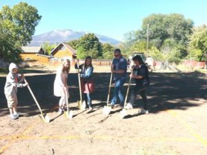 Breaking ground at the latest building site for Habitat for Humanity Ravalli County are prospective homeowner Jennifer Larson with her daughters Aksel and Emma Mitchell. Also pictured is David Haywod, Habitat for Humanity President of the Board, and volunteer Family Support Worker Christy Borgen.