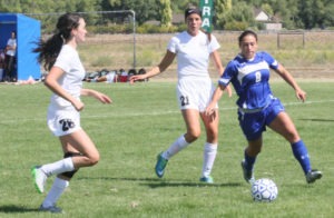 Corvallis’ Kenley Fields, flanked by two Billings Central players, looks to move the ball away from the defenders. Jean Schurman photo.