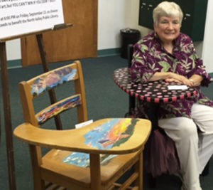 At 91, Beverly Helrich, President of the Friends of the North Valley Public Library for the past 12 years, still has the energy to organize the 5th (and final) Art of the Chair-Desk fundraiser to benefit the library. She’s pictured here with two of the painted chairs which are displayed in the foyer of the Kohl Building, behind Valley Drug. The silent auction ends Friday, September 23 at 6 p.m. A retirement party for Beverly will be held Wednesday, September 28 from 4 to 6:30 p.m. in the community room of the library which will close at 5 p.m. so that library staff can attend. Michael Howell photo.