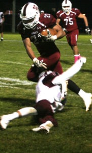 Hamilton’s Manny Rivera breaks a tackle and runs for the first Bronc touchdown of the Butte Central game. J. Schurman photo. 